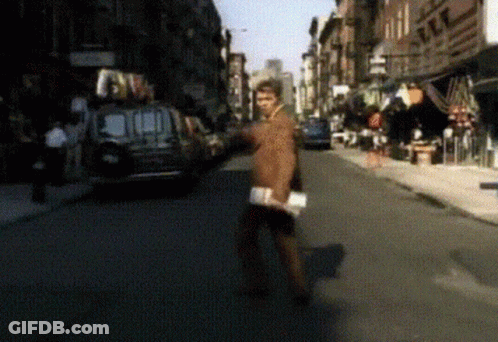Blurry Man Walking Down Street With Van GIF