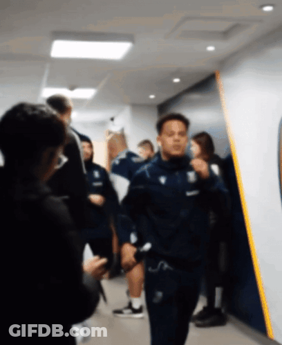 Blurry Man Walking In Hallway With Yellow Stripe GIF