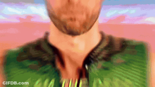 Blurry Man With Beard In Green Shirt Saying AA GIF