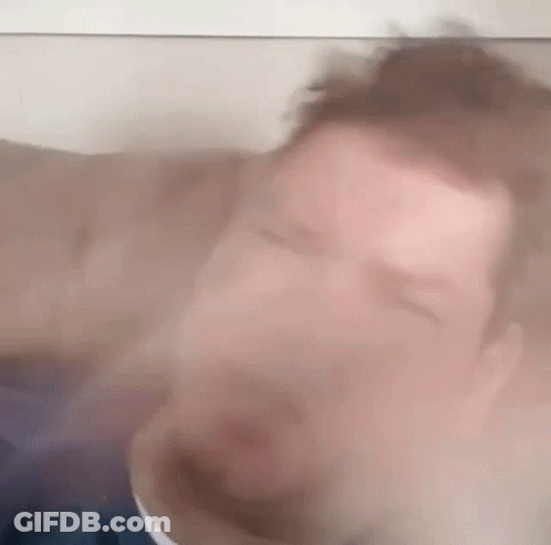 Blurry Man With Eyes Closed Behind Glass GIF