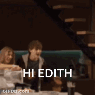 Blurry People At Table Saying Hi Edith GIF