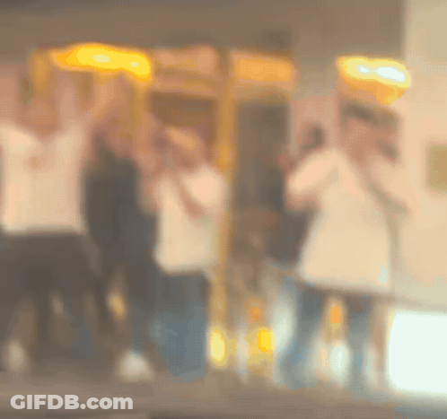 Blurry People Standing In Front Of Payphone GIF