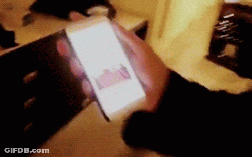 Blurry Person Holding Cell Phone GIF