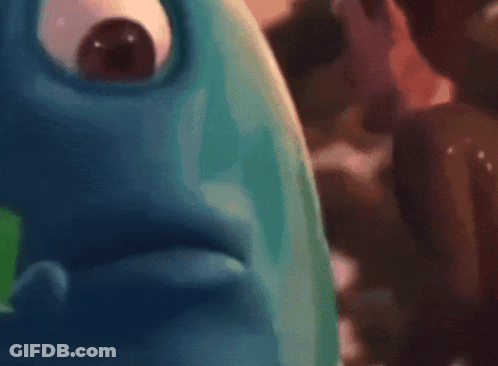 Blurry Person Holding Green Cube GIF