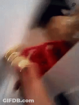Blurry Person Holding Red Item GIF