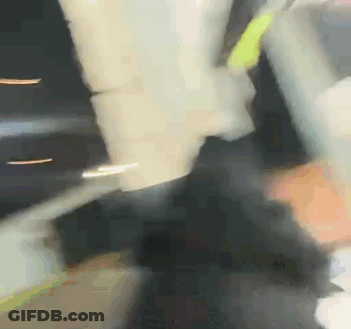 Blurry Person Holding Yellow Object GIF