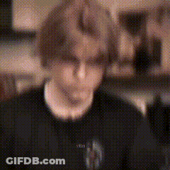 Blurry Person In Black Shirt And Necklace GIF