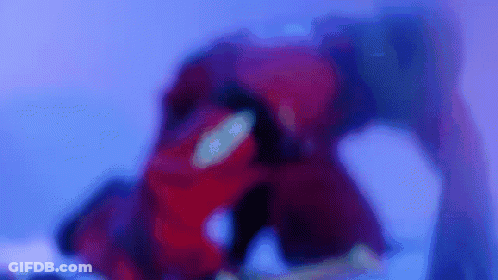 Blurry Person In Red Suit In Purple Room GIF