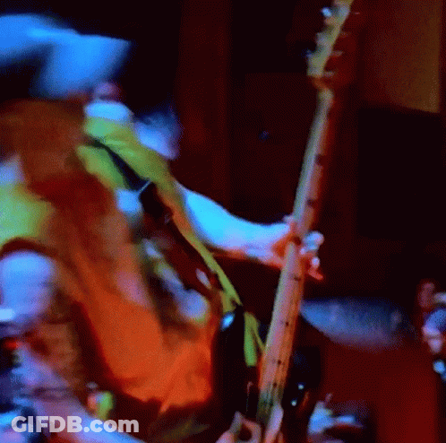Blurry Person Playing Guitar In Dark Room GIF