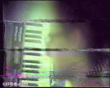 Blurry Person Playing Piano With Green Light GIF