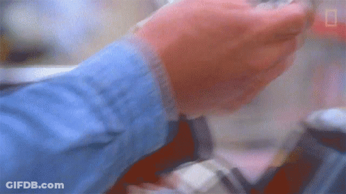 Blurry Person's Hands Holding Something GIF