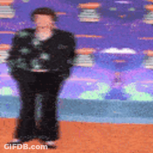 Blurry Person Standing Against Colorful Background GIF