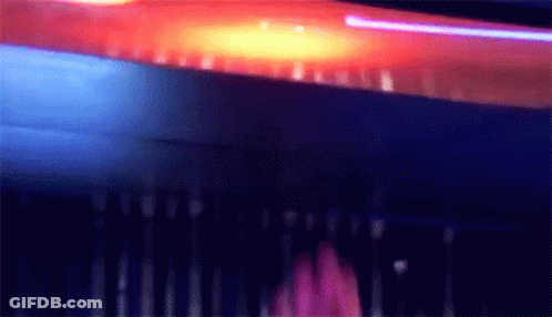 Blurry Person Standing In Dark Room With Purple Light GIF