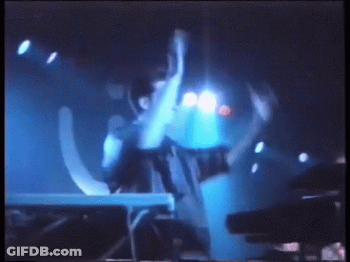 Blurry Person Standing In Front Of Blue Light GIF