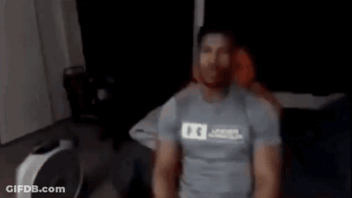 Blurry Person Standing Next To Fan GIF