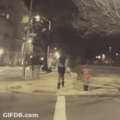 Blurry Person Walking On Sidewalk At Night GIF