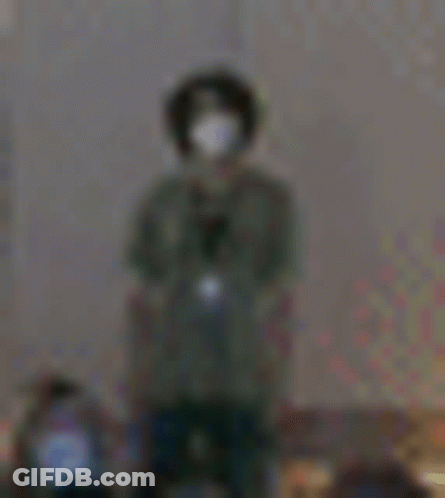 Blurry Person Wearing Mask And Headphones GIF