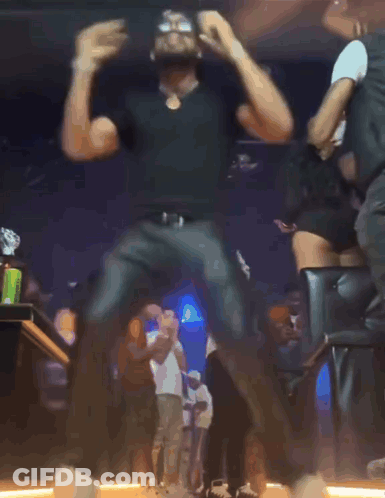 Blurry Photo Of Man Dancing With Arms Outstretched GIF