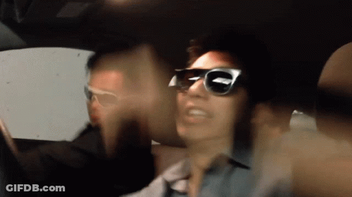 Blurry Photo Of Man In Sunglasses In Car GIF