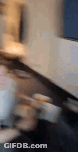 Blurry Photo Of Person Sitting At Desk GIF