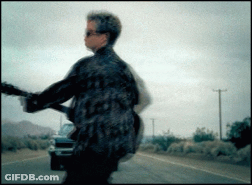 Blurry Picture Of Man Playing Guitar GIF