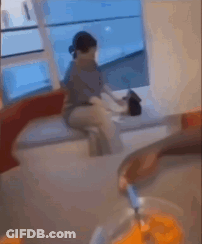 Blurry Picture Of Man Sitting At Table With Bowl Of Chips GIF