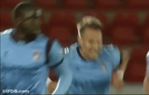 Blurry Soccer Player In Blue Jersey Celebrating GIF