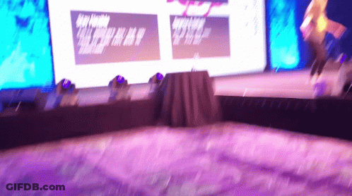 Blurry Stage With Purple Carpet And Large A Screen GIF