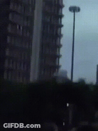 Blurry Street Light And Tall Building GIF