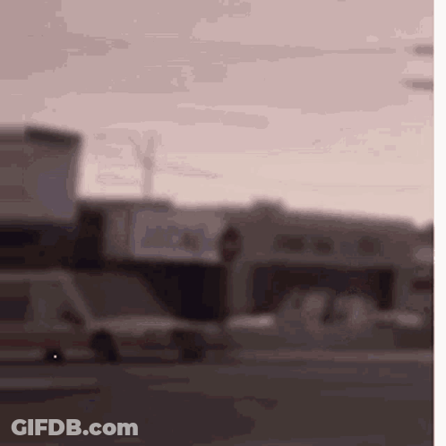 Blurry Street With Cars And Buildings GIF