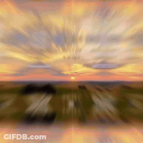 Blurry Sunset Sun Shining Through Clouds GIF