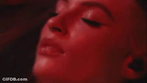 Blurry Woman Face With Red Light Behind GIF