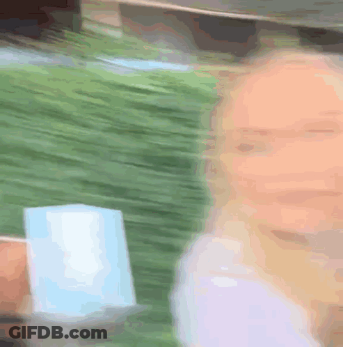 Blurry Woman Holding Cup GIF