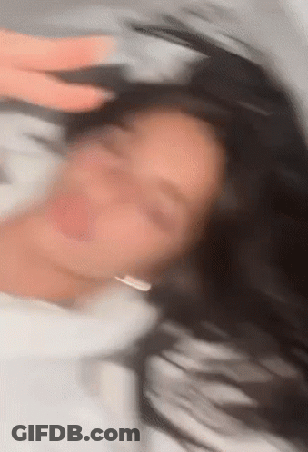 Blurry Woman Laying On Bed With Eyes Closed GIF