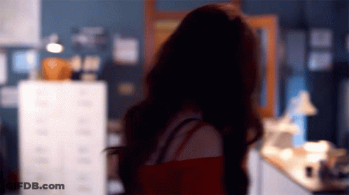 Blurry Woman Standing With Back To Camera GIF