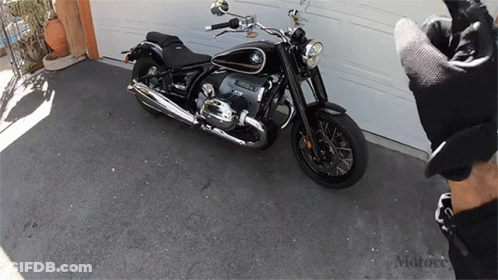 BMW Motorcycle Parked In Front Of Garage GIF
