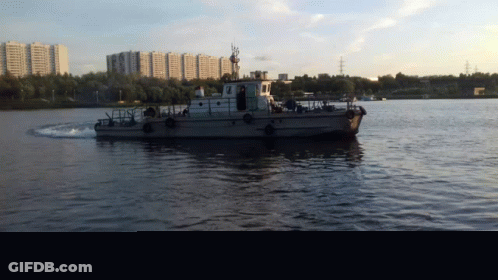 Boat Floating On Water With City GIF