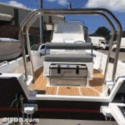 Boat With Cooler On Deck In Parking Lot GIF