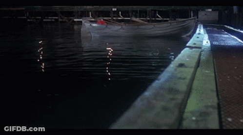 Boat With Red Oar Floating On Water GIF