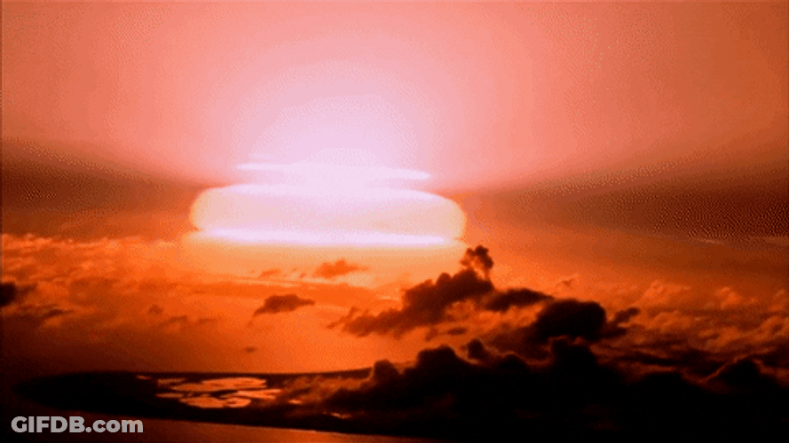 Bomb Explosion Illuminates The Horizon At Dusk GIF