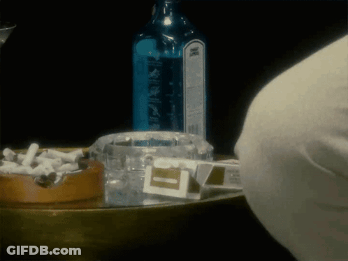 Bombay Sapphire Bottle Next To Ashtray Full Of Cigarettes GIF