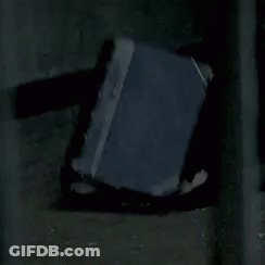 Book On Ground In Dark Room GIF