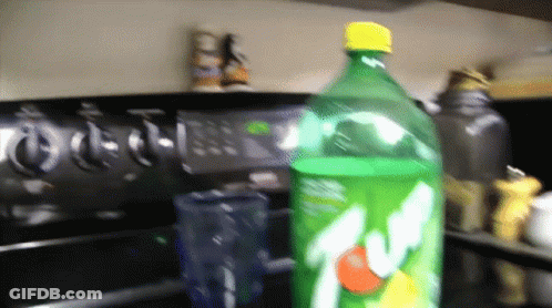 Bottle Of 7 Up On Stove Top GIF
