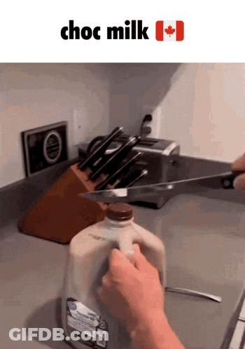 Bottle Of Choc Milk Cut With Knife GIF