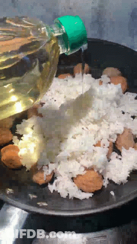 Bottle Of Oil Poured Over Rice GIF