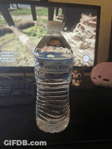 Bottle Of Spring Water In Front Of Monitor GIF