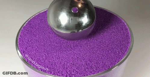 Bowl Of Purple Sand With Silver Ball GIF