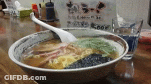 Bowl Of Ramen With Spoon On Wooden Table GIF