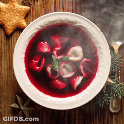 Bowl Of Soup With Spoon And Star Cookie On Wooden Table GIF