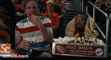 Box Of Hot Dogs On Table In Front Of Crowd GIF